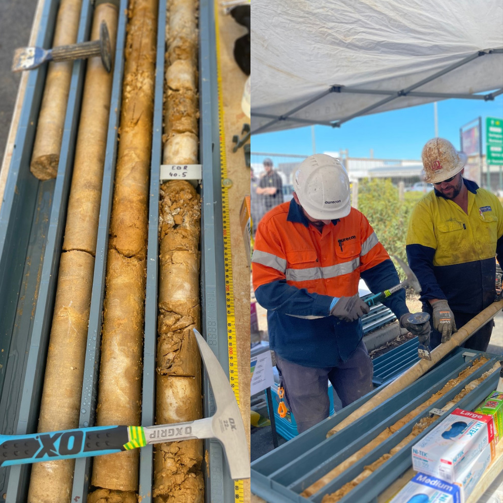 Two workers in Hi-Vis inspecting core samples.